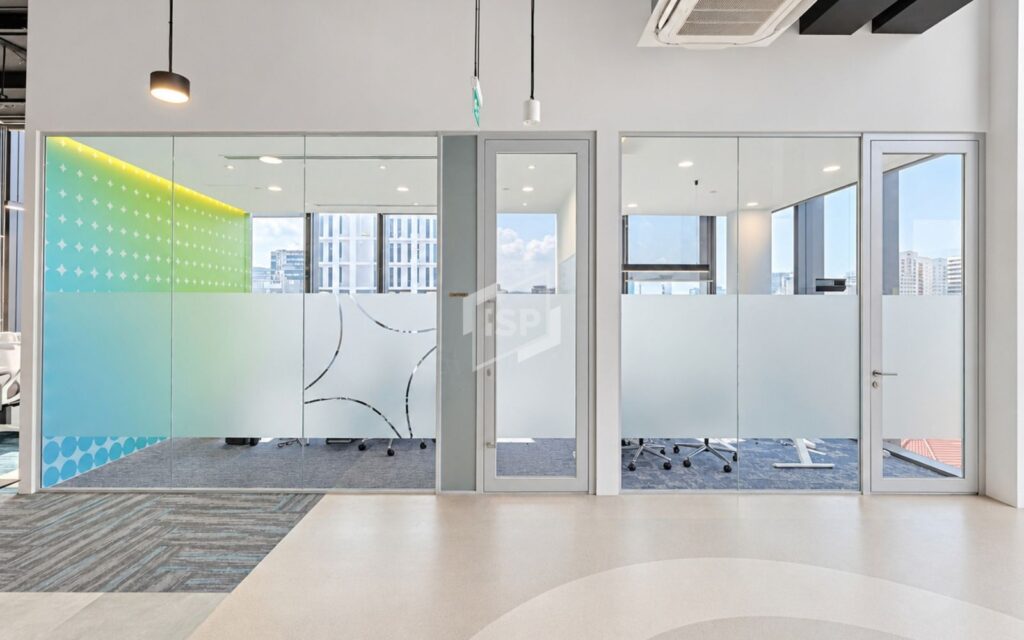 Glass meeting rooms with frosted privacy film and colourful custom decals in a modern office