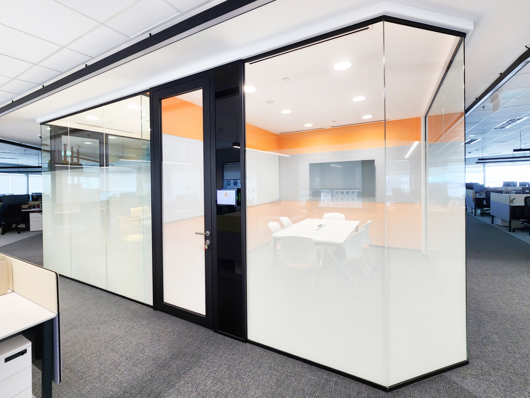 Office Meeting Room with Segmented Glass Design and Tech Panel